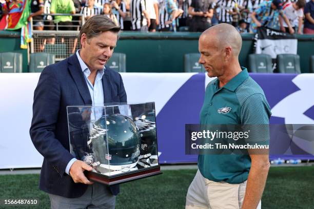Premier League CEO Richard Masters receives a commemorative Philadelphia Eagles helmet during the Premier League Summer Series match between Aston...