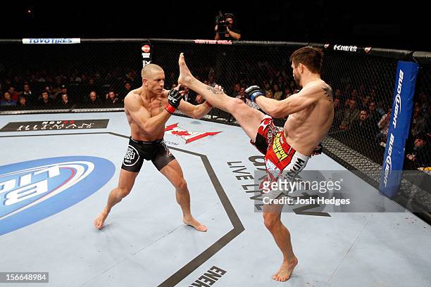Carlos Condit attempts a kick against Georges St-Pierre in their welterweight title bout during UFC 154 on November 17, 2012 at the Bell Centre in...