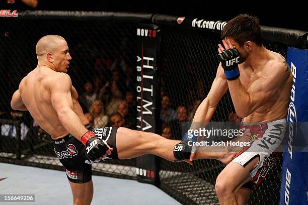 Georges St-Pierre throws a kick against Carlos Condit in their welterweight title bout during UFC 154 on November 17, 2012 at the Bell Centre in...