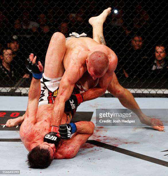 Georges St-Pierre throws a punch to the face of Carlos Condit in their welterweight title bout during UFC 154 on November 17, 2012 at the Bell Centre...