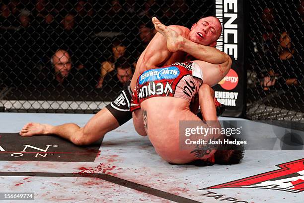 Carlos Condit grapples against Georges St-Pierre in their welterweight title bout during UFC 154 on November 17, 2012 at the Bell Centre in Montreal,...