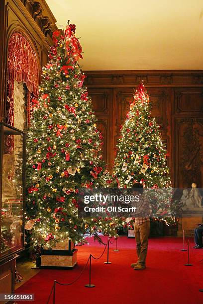 National Trust employee adjusts the Christmas decorations in the East Gallery of Waddesdon Manor on November 16, 2012 in Aylesbury, England. The East...