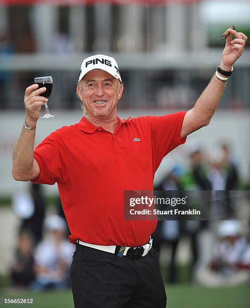 Miguel Angel Jimenez of Spain celebrates winning with a glass of red wine and a cigar after the final round of the UBS Hong Kong open at The Hong...