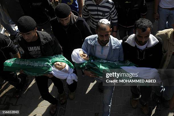 Palestinians carry the body of Jumana Abu Sefan , 18 months, and her brother Tamer, three and a half years old, during their funeral in the village...