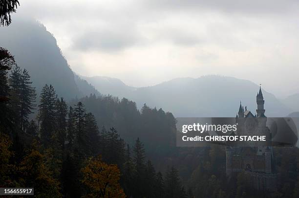 The castle Neuschwanstein near Fuessen, in the Allgaeu Alps mountains, southern Germany, is seen in autumn atmosphere and foggy weather on October...