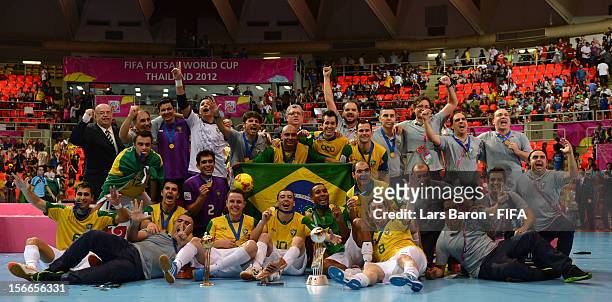 Players of Brazil celebrate with the trophy after winning the FIFA Futsal World Cup Final at Indoor Stadium Huamark on November 18, 2012 in Bangkok,...