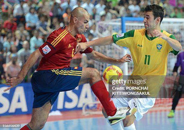 Neto of Brazil battles for the ball with Fernandao of Spain on the way to Brazil winning the final match of the FIFA Futsal World Cup 2012 in Bangkok...