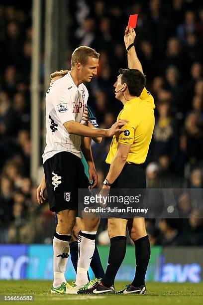 Brede Hangeland of Fulham is shown a straight red card by Referee Lee Probert following a dangerous tackle during the Barclays Premier League match...