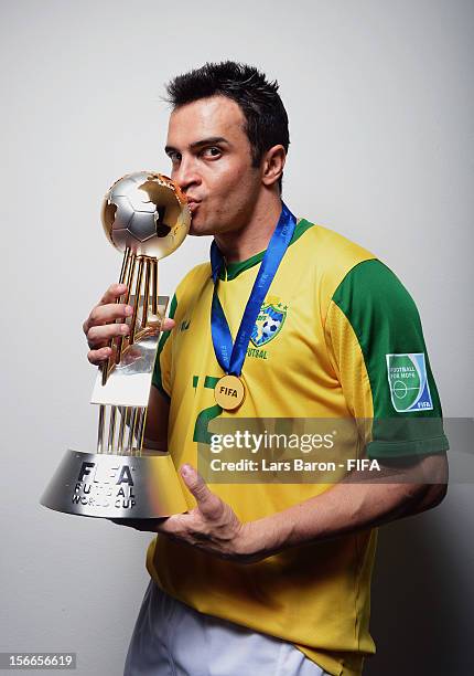 Falcao of Brazil poses with the trophy in the locker room after winning the FIFA Futsal World Cup Final at Indoor Stadium Huamark on November 18,...