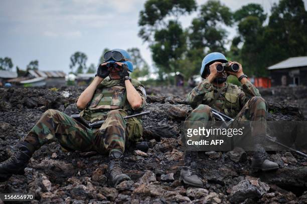 Uruguayan United Nations peacekeepers look through binoculars at M23 rebel positions on the outskirts of Goma, in eastern Democratic Republic of the...