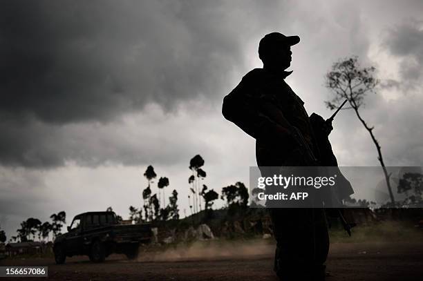 An M23 rebel stands guard in the village of Kanyarucinya, some 6km from Goma, in eastern Democratic Republic of the Congo, on November 18, 2012....