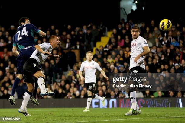 Carlos Cuellar of Sunderland rises above Steve Sidwell of Fulham to score his team's second goal during the Barclays Premier League match between...