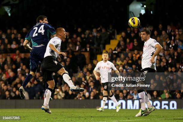 Carlos Cuellar of Sunderland rises above Steve Sidwell of Fulham to score his team's second goal during the Barclays Premier League match between...