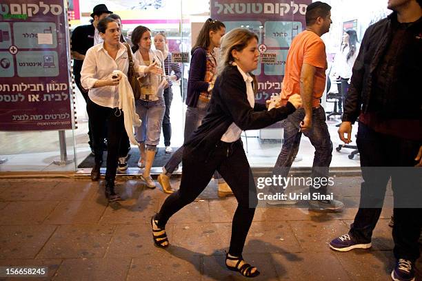 Israelis run for cover during a rocket attack on November 18, 2012 in Tel Aviv, Israel. At least 53 Palestinians and three Israeli's have died since...