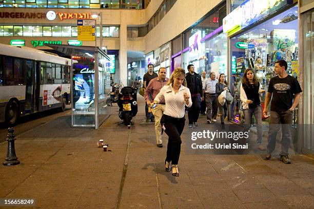 Israelis run for cover during a rocket attack on November 18, 2012 in Tel Aviv, Israel. At least 53 Palestinians and three Israeli's have died since...