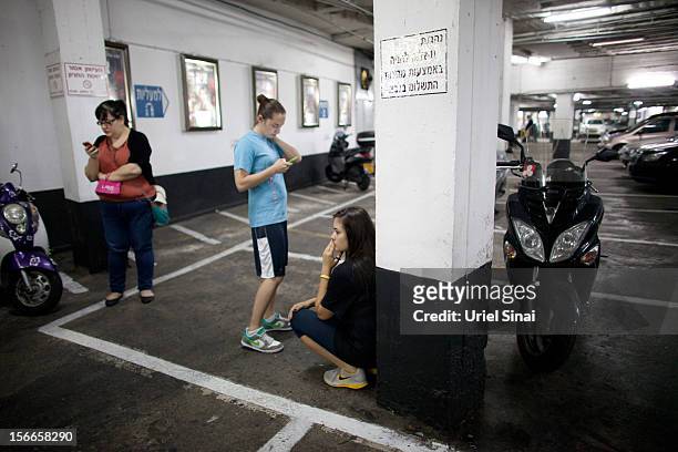 Israelis take cover at a shopping centre parking garage during a rocket attack on November 18, 2012 in Tel Aviv, Israel. At least 53 Palestinians and...