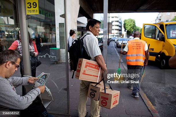 Man carries gas masks after taking them from a distribution center on November 18, 2012 in Tel Aviv, Israel. At least 53 Palestinians and three...