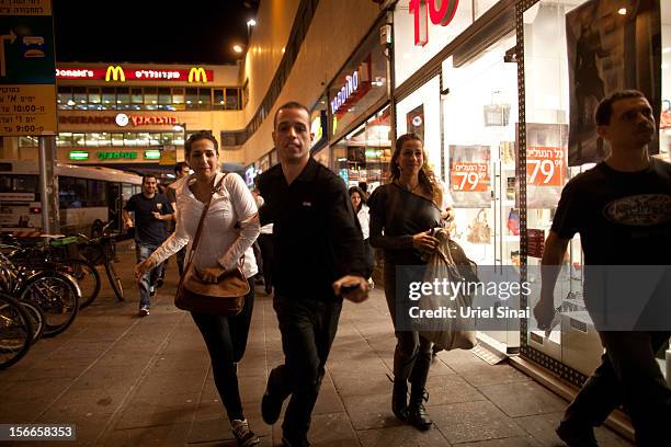 Israelis run for cover during a rocket attack on November 18, 2012 in Tel Aviv, Israel. At least 53 Palestinians and three Israeli's have died since...