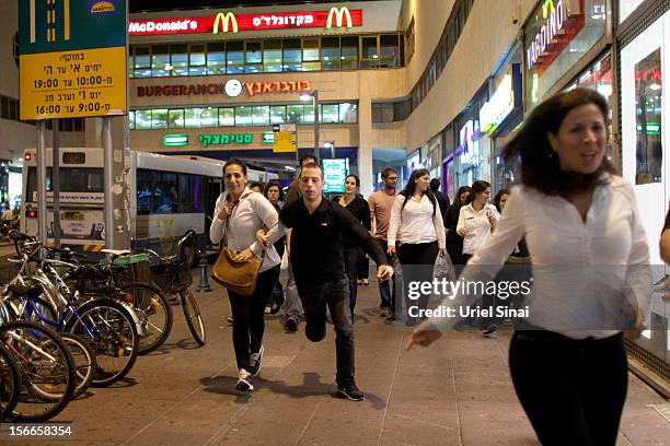 Israelis run for cover during a rocket attack on November 18, 2012 in Tel Aviv, Israel. At least 53 Palestinians and three Israeli's have died since...