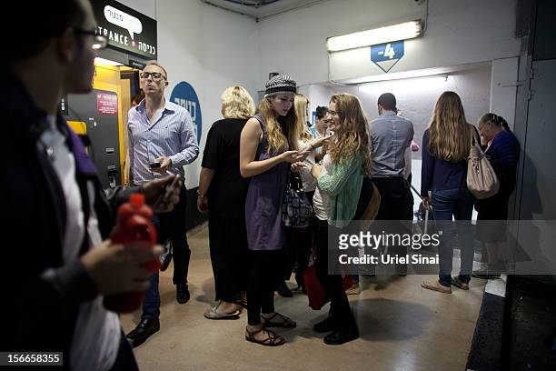 Israelis take cover at a shopping centre parking garage during a rocket attack on November 18, 2012 in Tel Aviv, Israel. At least 53 Palestinians and...