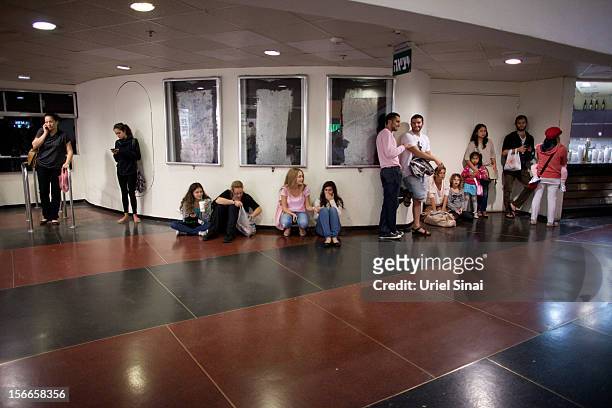 Israelis take cover at a shopping centre during a rocket attack on November 18, 2012 in Tel Aviv, Israel. At least 53 Palestinians and three...