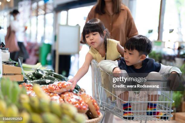 mother and children enjoy shopping fresh vegetables in the greengrocers at convenience store - korean ethnicity stock pictures, royalty-free photos & images