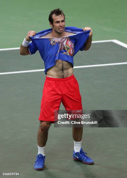 Radek Stepanek of Czech Republic rips his shirt after celebrating match point against Nicolas Almagro of Spain during day three of the final Davis...