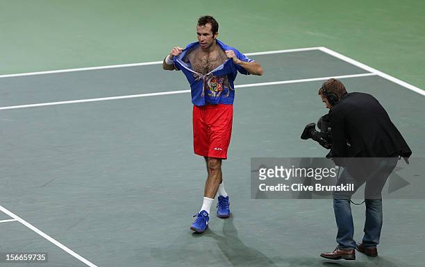 Radek Stepanek of Czech Republic rips his shirt after celebrating match point against Nicolas Almagro of Spain during day three of the final Davis...