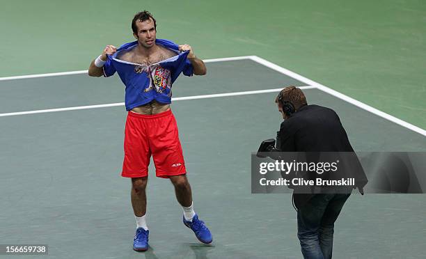 Radek Stepanek of Czech Republic rips his shirt after celebrating match point against Nicolas Almagro of Spain during day three of the final Davis...