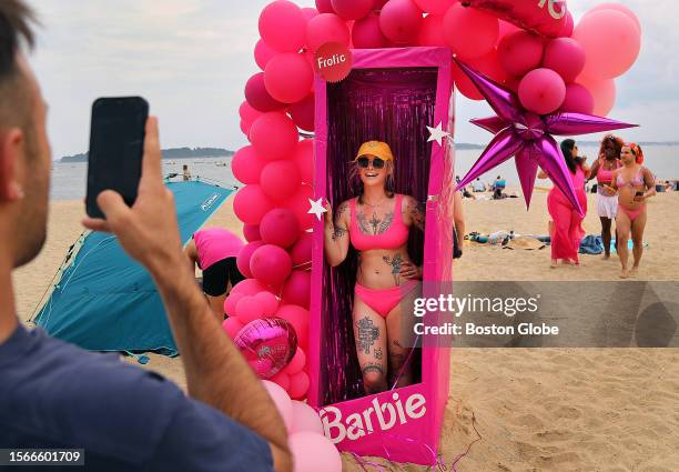 Caroline Ballerstedt has her photo taken in a Barbie box. A Barbie Beach Party was held at M Street Beach where beachgoers wore beach attire in pink...