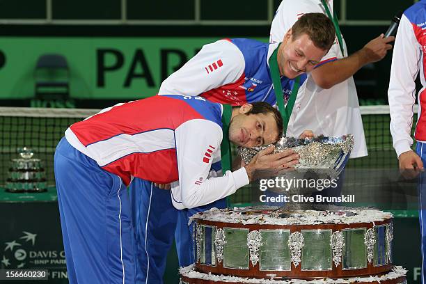 Tomas Berdych of the Czech Republic laughs at his team mate Radek Stepanek as he hugs the trophy after a 3-2 victory against Spain during day three...