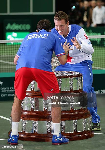 Tomas Berdych of the Czech Republic and his team mate Radek Stepanek take a closer look at the trophy after a 3-2 victory against Spain during day...