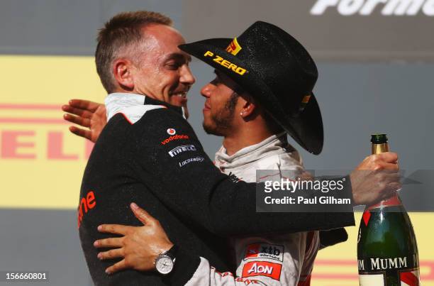 Lewis Hamilton of Great Britain and McLaren celebrates on the podium with his Team Principal Martin Whitmarsh after winning the United States Formula...