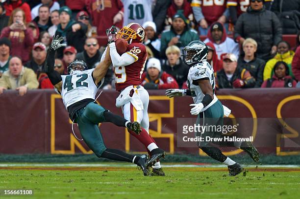 Santana Moss of the Washington Redskins catches a pass for a touchdown in between Kurt Coleman and Brandon Boykin of the Philadelphia Eagles at FedEx...