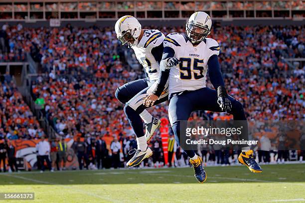Eric Weddle of the San Diego Chargers celebrates his 23 yard interception for a touchdown with Shaun Phillips of the San Diego Chargers against the...