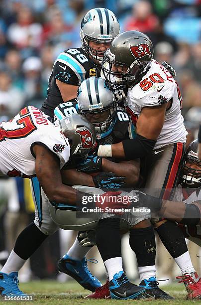 Jonathan Stewart of the Carolina Panthers is tackled by Daniel Te'o-Nesheim of the Tampa Bay Buccaneers during their game at Bank of America Stadium...