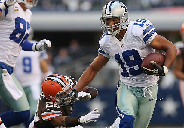 Miles Austin of the Dallas Cowboys runs the ball against Trevin Wade of the Cleveland Browns at Cowboys Stadium on November 18, 2012 in Arlington,...