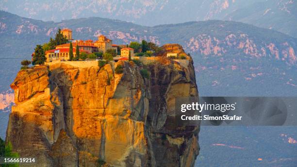 monasteries on meteora with mountain in background - meteora stock pictures, royalty-free photos & images