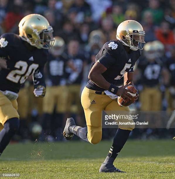 Everett Golson of the Notre Dame Fighting Irish rolls out with Cierre Wood against the Wake Forest Demon Deacons at Notre Dame Stadium on November...