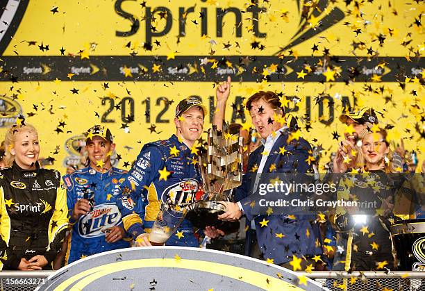 Chairman and CEO Brian France presents Brad Keselowski, driver of the Miller Lite Dodge, with the series trophy in Champions Victory Lane after...