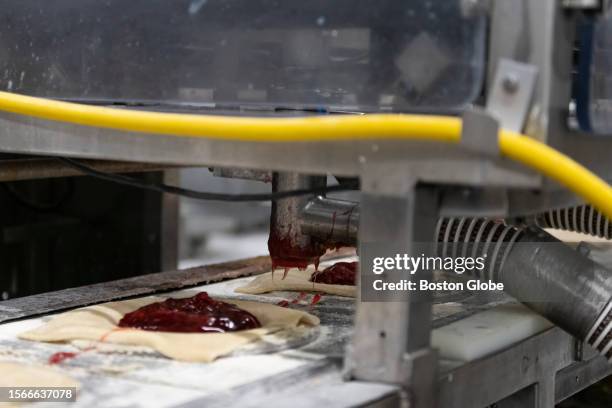 Worcester, MA A machine fills pie crusts with cherry filling at the Table Talk Pies facility. Table Talk Pies has three manufacturing lines that can...