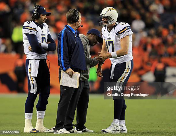 Head coach Norv Turner of the San Diego Chargers talks to quarterback Philip Rivers of the San Diego Chargers as quarterback Charlie Whitehurst of...