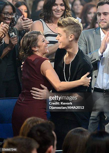 Singer Justin Bieber and mother Pattie Malette hug in the audience at the 40th American Music Awards held at Nokia Theatre L.A. Live on November 18,...