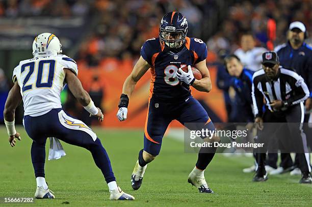 Tight end Joel Dreessen of the Denver Broncos makes a first down reception as cornerback Antoine Cason of the San Diego Chargers defends at Sports...