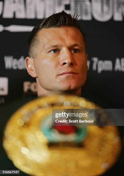 Danny Green of Australia looks on in front of the International Boxing Organization World Champion Belt as it sits on display during a press...