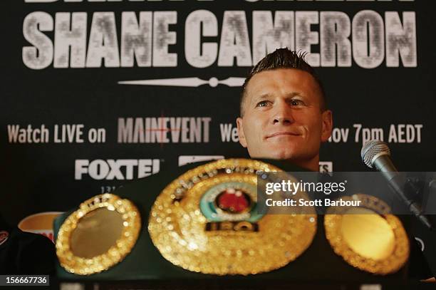 Danny Green of Australia looks on in front of the International Boxing Organization World Champion Belt as it sits on display during a press...