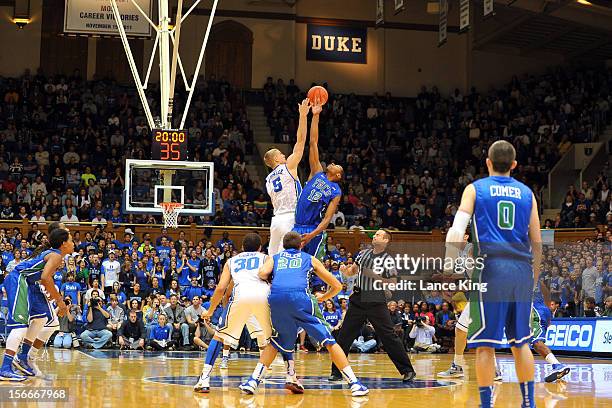 Mason Plumlee of the Duke Blue Devils and Eric McKnight of the Florida Gulf Coast Eagles jump for the opening tip at Cameron Indoor Stadium on...