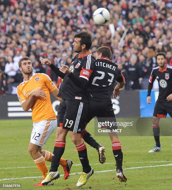 United defender Emiliano Dudar and United defender Perry Kitchen head away a Houston Dynamo pass, as Houston Dynamo forward Will Bruin looks on,...