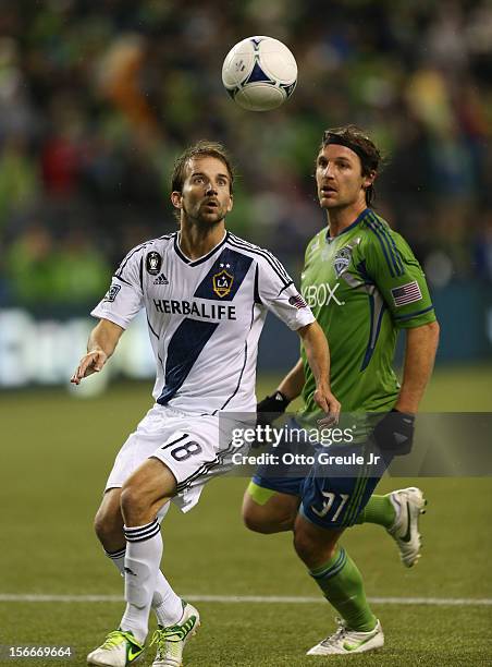 Mike Magee of the Los Angeles Galaxy battles Jeff Parke of the Seattle Sounders FC during Leg 2 of the Western Conference Championship at CenturyLink...