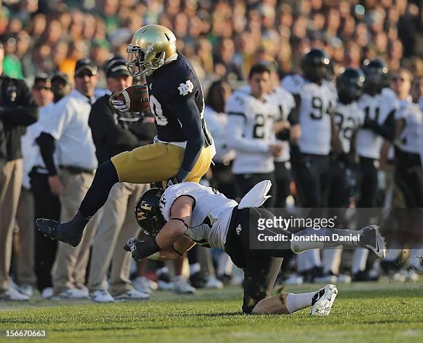 Cierre Wood is hit by Mike Olson of the Notre Dame Fighting Irish of the Wake Forest Demon Deacons at Notre Dame Stadium on November 17, 2012 in...